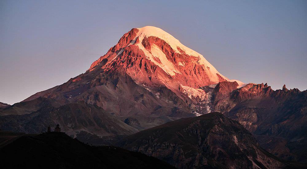 Mount Kazbegi with hiker in foreground